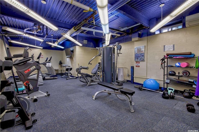 workout area featuring a wall unit AC