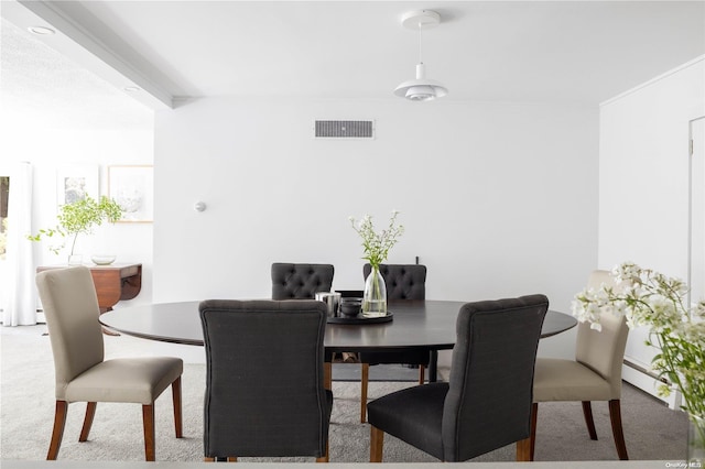 dining space with light carpet and a baseboard heating unit