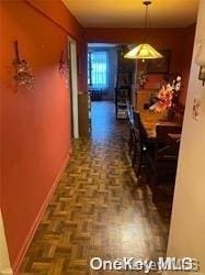 corridor featuring dark parquet floors