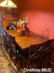 unfurnished dining area featuring parquet floors