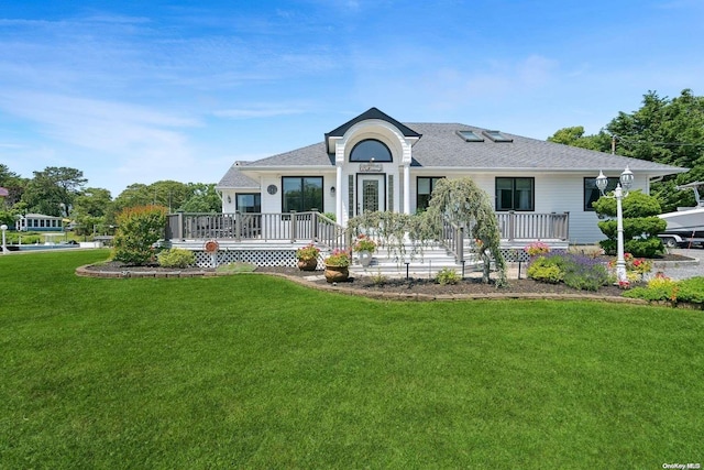 14C Penny Ln, Hampton Bays, NY 11946 - view of front of home featuring a front yard, a shingled roof, and covered porch