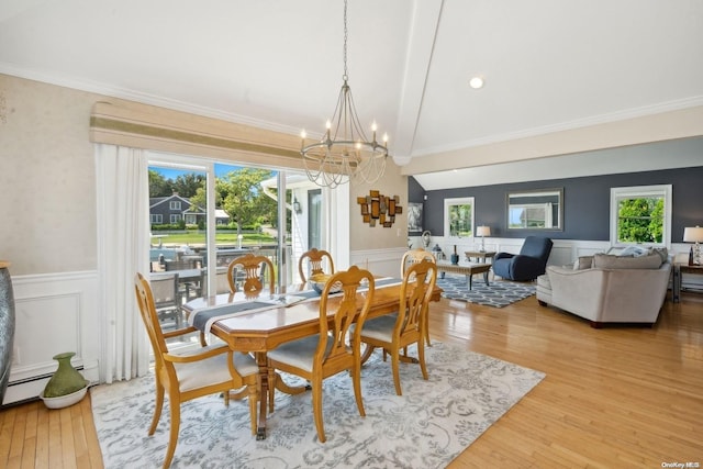 14C Penny Ln, Hampton Bays, NY 11946 - dining area with a chandelier, a wainscoted wall, light wood finished floors, ornamental molding, and a decorative wall
