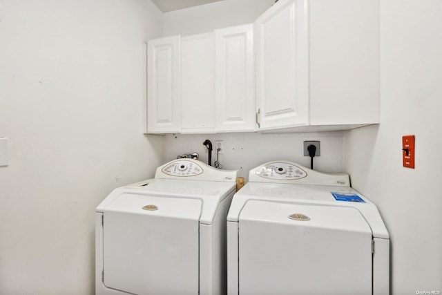 laundry area with cabinets and washing machine and dryer