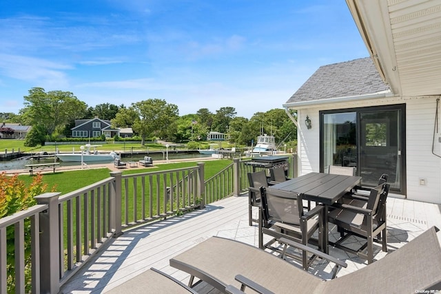 deck featuring a lawn and a water view