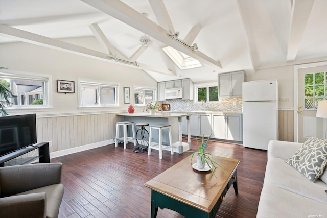 14C Penny Ln, Hampton Bays, NY 11946 - living area featuring a skylight, wainscoting, dark wood finished floors, and ceiling fan