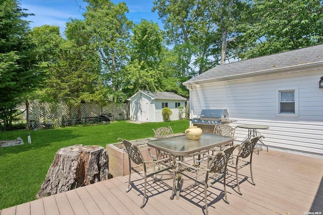 wooden deck with a lawn, a storage shed, and grilling area