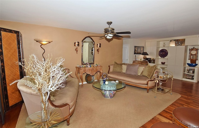 living room featuring hardwood / wood-style floors and ceiling fan