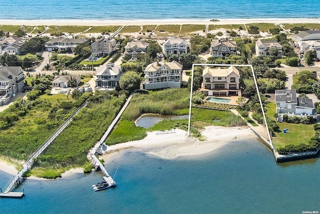 drone / aerial view featuring a view of the beach and a water view