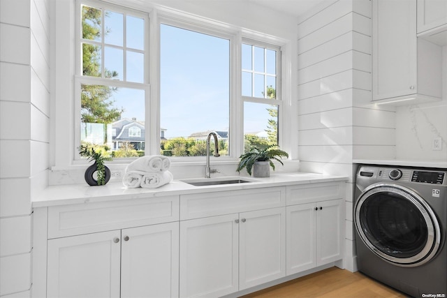 washroom with cabinets, washer / clothes dryer, light hardwood / wood-style flooring, and sink