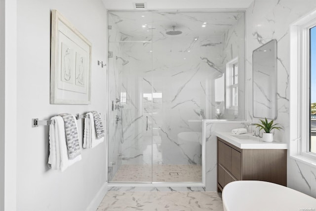 bathroom with vanity, a wealth of natural light, and a shower with shower door