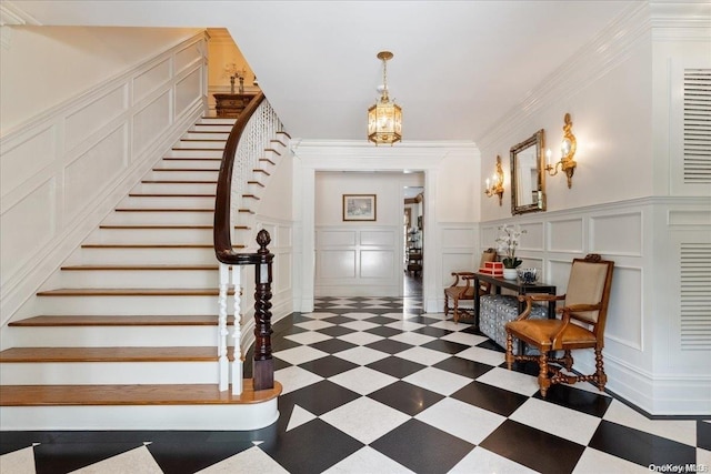 entryway featuring ornamental molding