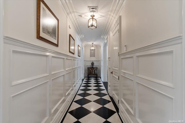 hall featuring a chandelier and ornamental molding