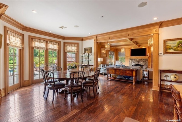 dining area with french doors, dark wood-type flooring, coffered ceiling, and ornamental molding