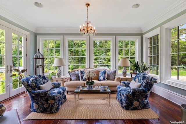 sunroom featuring a chandelier and french doors