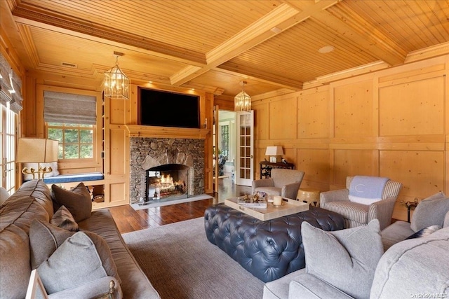 living room with a fireplace, hardwood / wood-style flooring, beamed ceiling, and wood ceiling