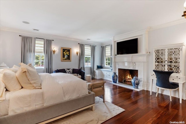 bedroom with dark hardwood / wood-style floors, ornamental molding, a high end fireplace, and multiple windows