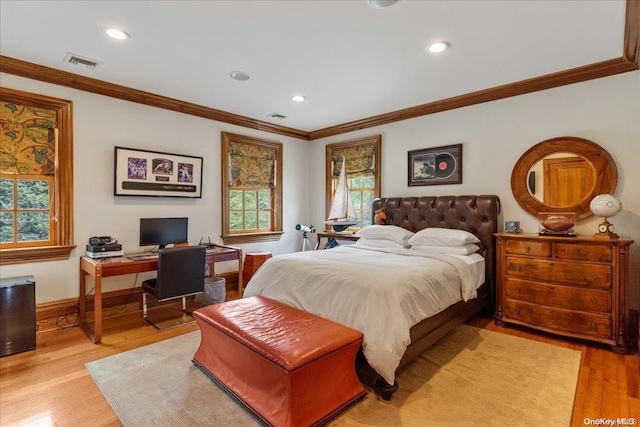 bedroom featuring light hardwood / wood-style flooring and crown molding