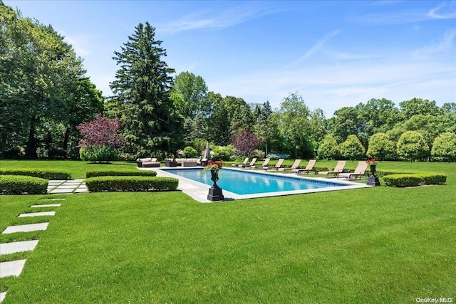 view of pool with a lawn