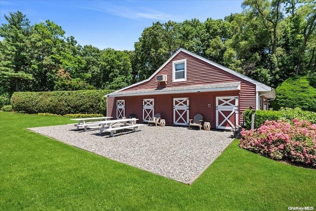 view of outbuilding with a yard