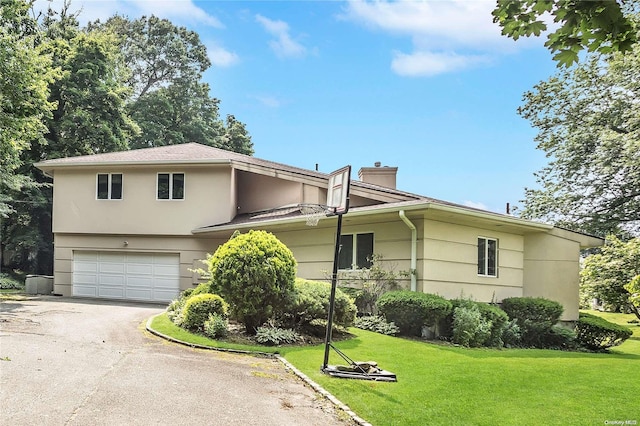 view of front property with a front yard and a garage