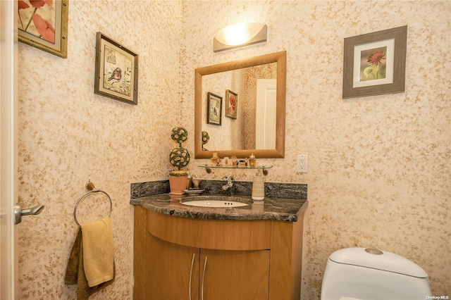 bathroom featuring vanity and toilet