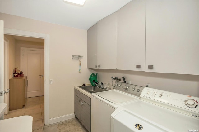 laundry area featuring cabinets, independent washer and dryer, sink, and light tile patterned floors