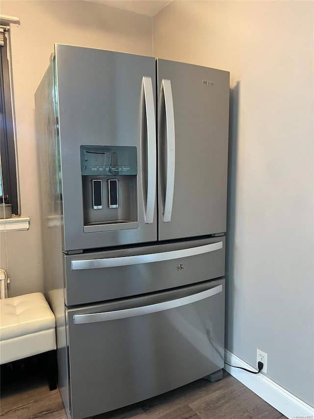 details with dark hardwood / wood-style floors and stainless steel fridge