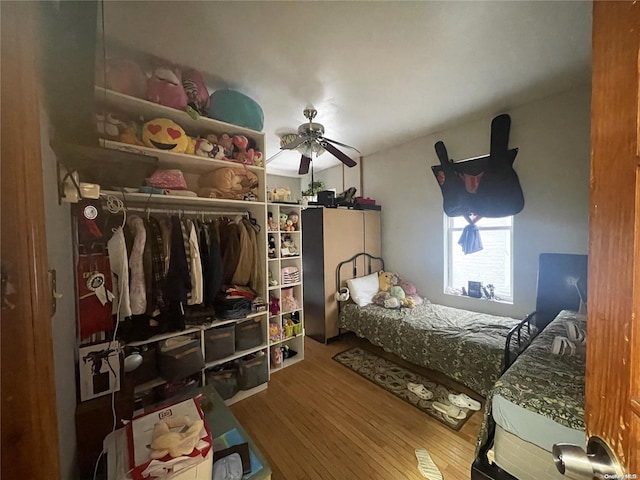 bedroom with ceiling fan and hardwood / wood-style floors