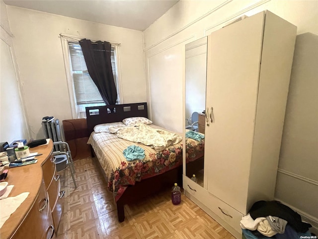 bedroom with light parquet flooring