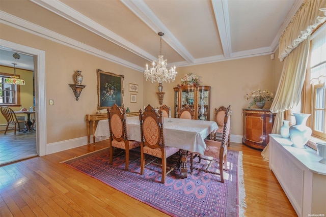 dining space with beamed ceiling, ornamental molding, light hardwood / wood-style flooring, and a notable chandelier