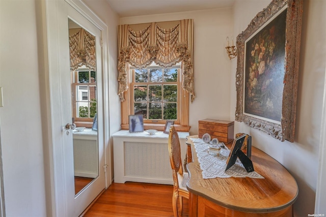 interior space with radiator and hardwood / wood-style floors