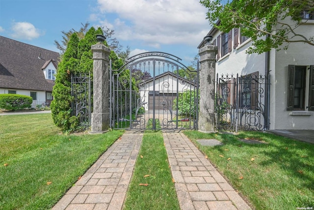 view of gate with a yard