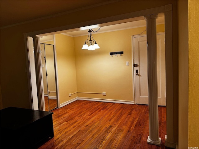 unfurnished dining area featuring hardwood / wood-style flooring, an inviting chandelier, and crown molding