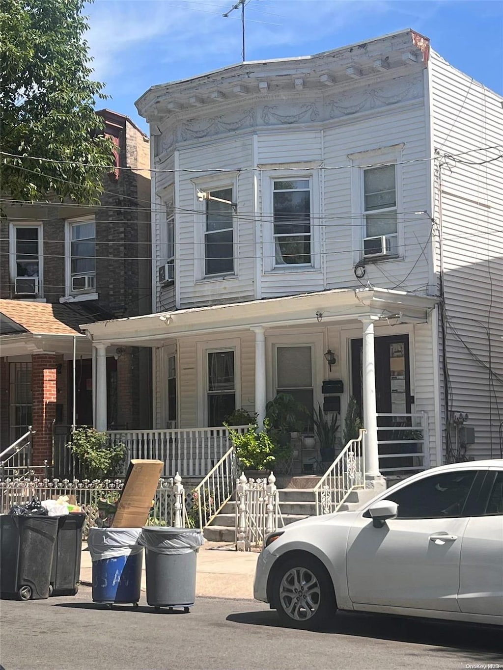 view of front facade featuring cooling unit and a porch