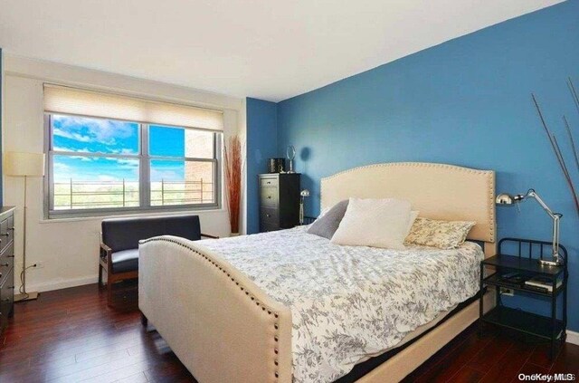 bedroom featuring dark wood-type flooring