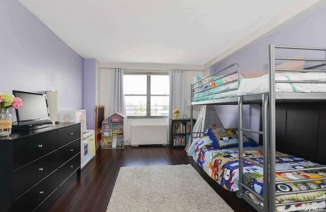 bedroom featuring dark hardwood / wood-style floors and radiator