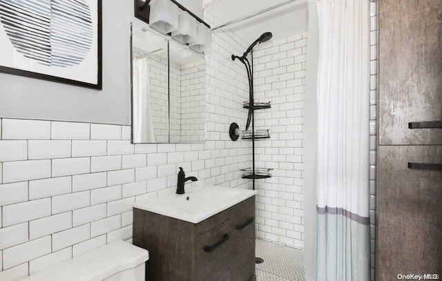 bathroom featuring vanity, decorative backsplash, toilet, walk in shower, and tile walls