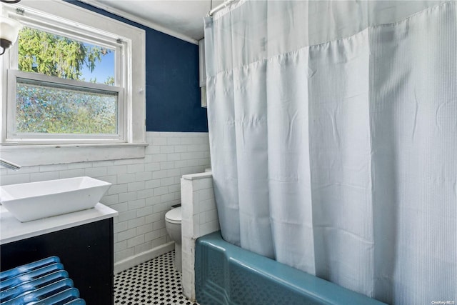 full bathroom with toilet, shower / tub combo with curtain, vanity, tile walls, and ornamental molding