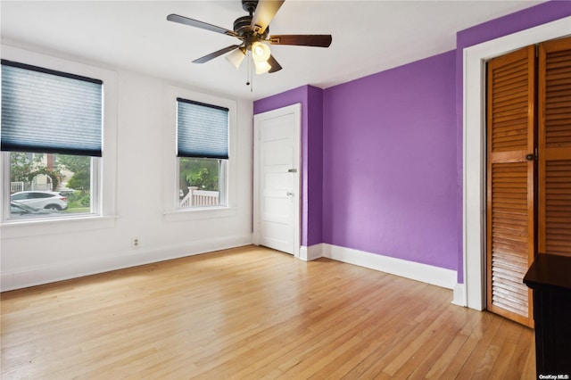 unfurnished bedroom with a closet, light hardwood / wood-style floors, and ceiling fan