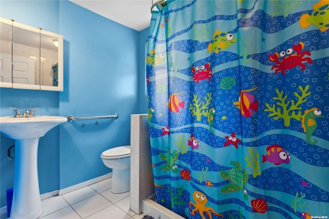 bathroom with tile patterned floors, sink, toilet, and walk in shower