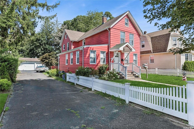 view of front of home with an outbuilding and a garage