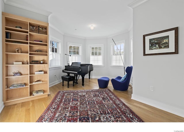 sitting room featuring wood-type flooring and ornamental molding