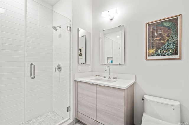 bathroom with vanity, toilet, and an enclosed shower