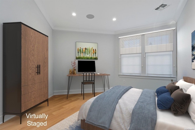 bedroom featuring wood-type flooring and crown molding