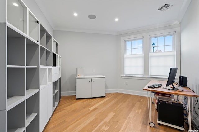 office area with light hardwood / wood-style floors and ornamental molding