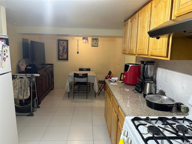 kitchen featuring light tile patterned floors, white appliances, tasteful backsplash, and extractor fan