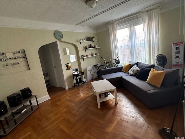 living room with a textured ceiling and parquet floors