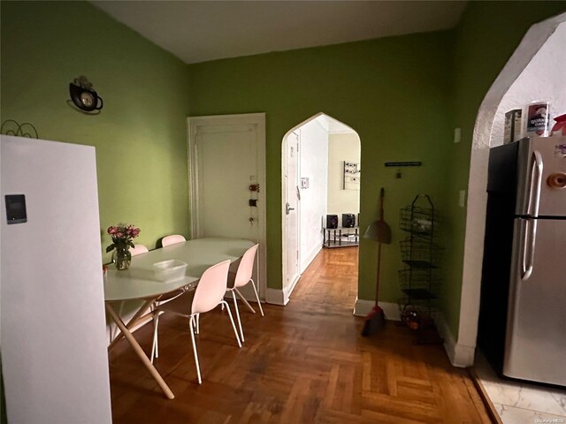 dining area with parquet flooring