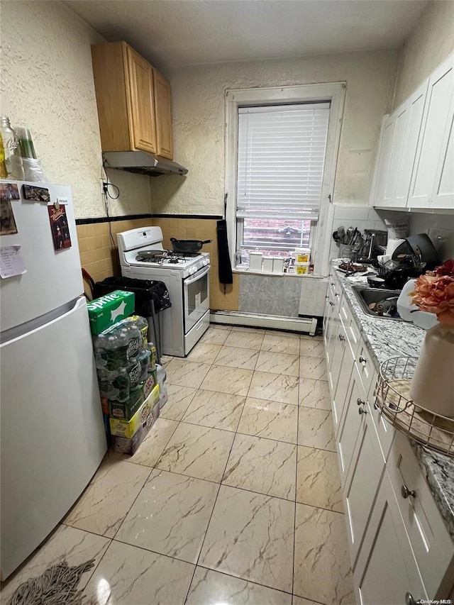 kitchen featuring white cabinets, light stone countertops, white appliances, and a baseboard radiator