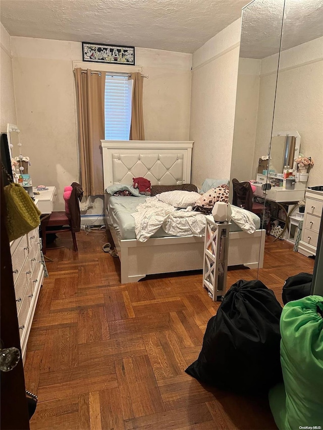 bedroom featuring dark parquet floors